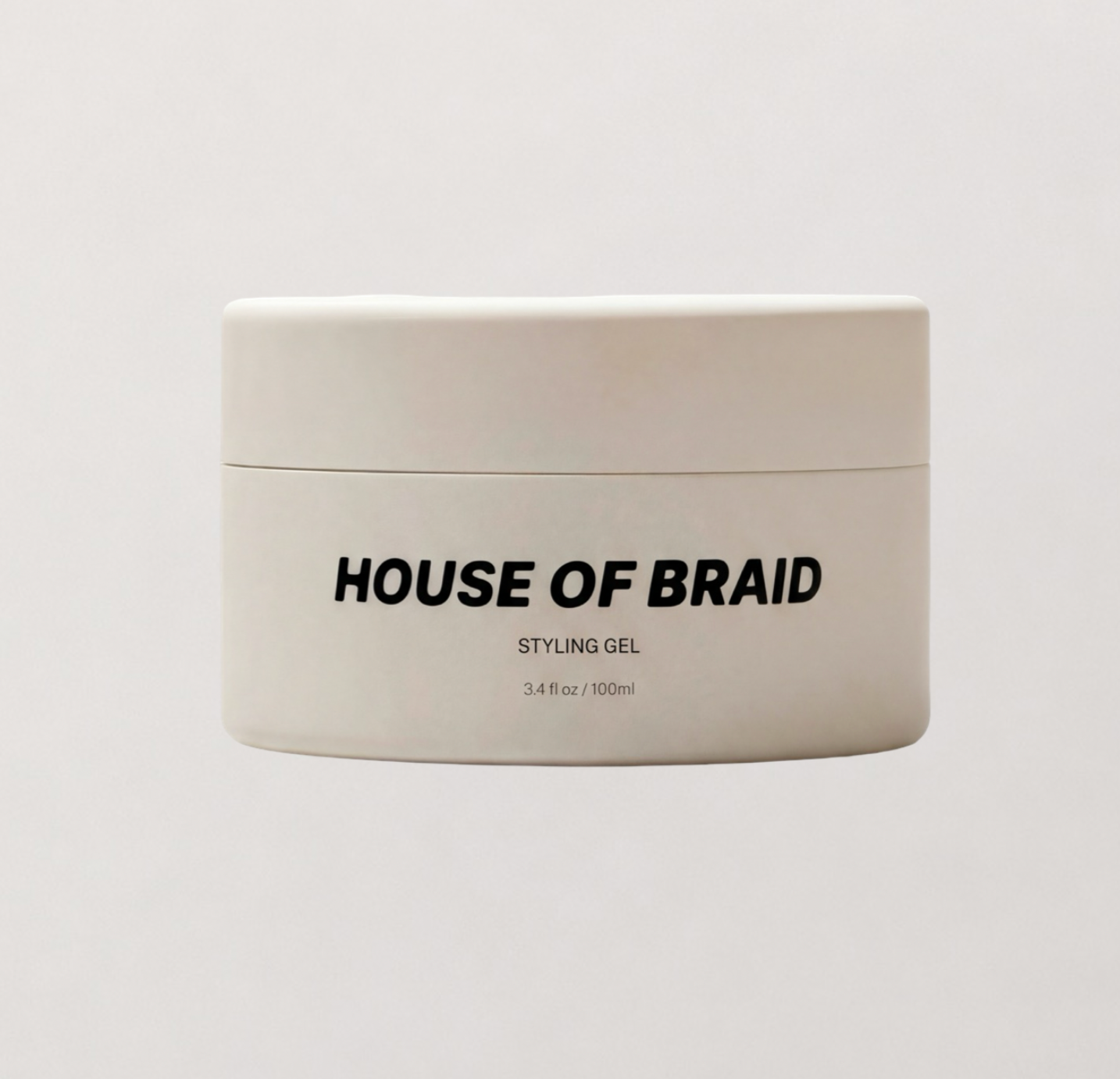 A white plastic jar of HOUSE OF BRAID Styling Gel with black text, centered on a light gray background.